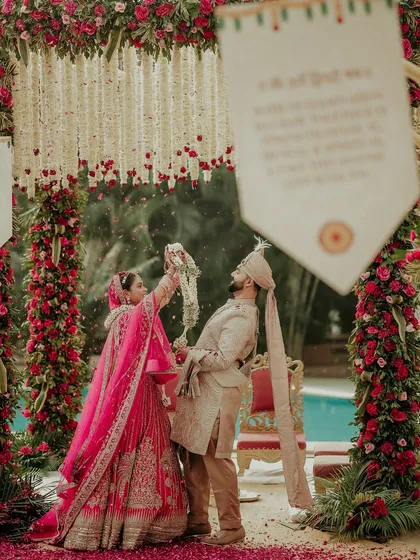 The Varmala ceremony is a beautiful blend of tradition and playful romance. I focus on capturing the action and emotion, like the bride's triumphant moment, surrounded by a stunning floral mandap and the vibrant colors of her lehenga.