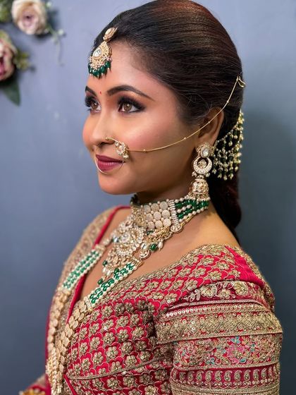 A side profile of a beautiful bride, showcasing her flawless makeup and elegant hairstyle.