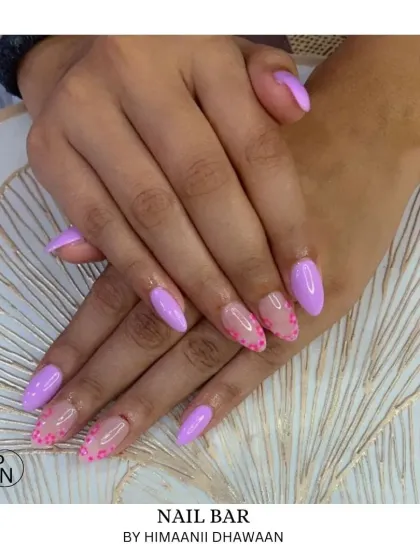 A pretty lavender manicure with a delicate dotted pattern on the accent nails.