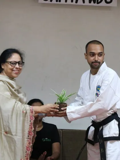 Receiving a token of appreciation from the faculty at Sri Aurobindo College. These collaborations with educational institutions are at the heart of our mission to build a safer community.