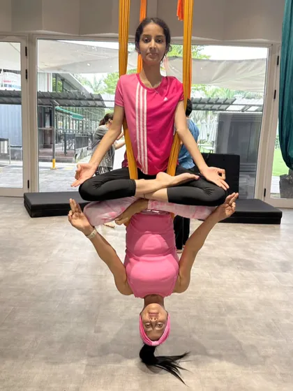 Mentoring is a huge part of my journey. Here, we created a serene and beautiful posture that looks like a lotus and its reflection. It’s a moment of peace and accomplishment, showing the artistic possibilities we can explore together in class.