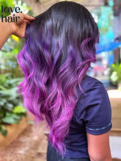 A stylist's hand showing the texture and flow of this stunning vivid color melt.