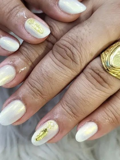 A soft, pearly white set on natural, rounded nails. We added a single gold leaf foil accent to two nails for a touch of understated elegance.