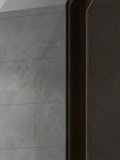 A detail shot of a wardrobe concept combining dark wood veneer with a grey marble-finish panel, showcasing our ability to work with luxurious and contrasting materials.