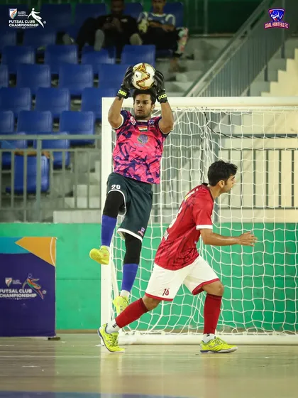 Our goalkeeper jumping to claim the ball.