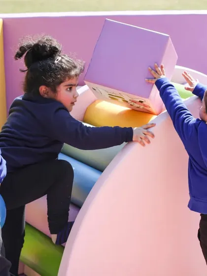 Kids working together to build and climb on our soft play blocks and structures.