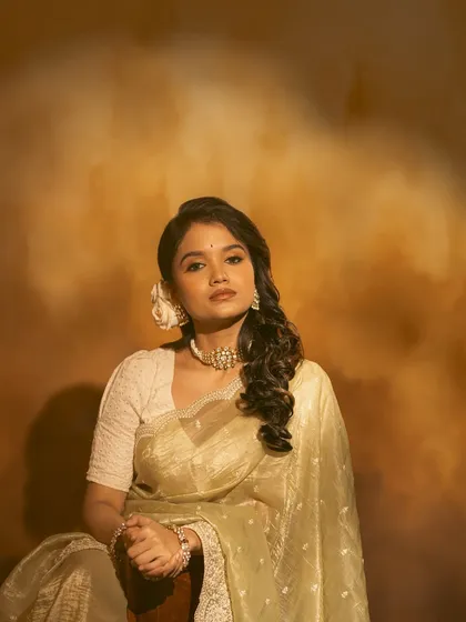 This image showcases the full retro look, with the saree, hairstyle, and jewellery coming together beautifully.