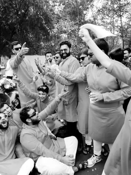 The baraat isn't just for the boys. This high-energy black and white shot shows the bride's side dancing and celebrating in the street, full of joy and excitement.