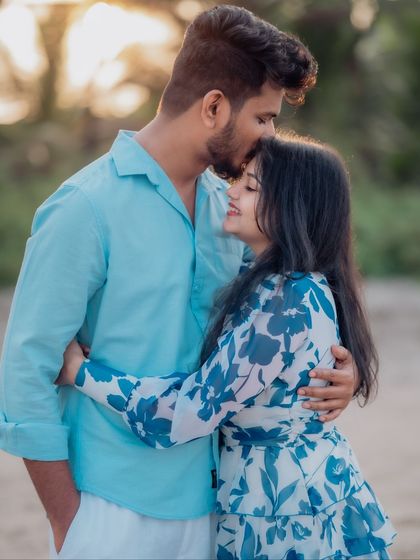 A tender forehead kiss is a simple yet powerful expression of love. This close-up shot from a beach photoshoot focuses on the couple's gentle affection and emotional connection.