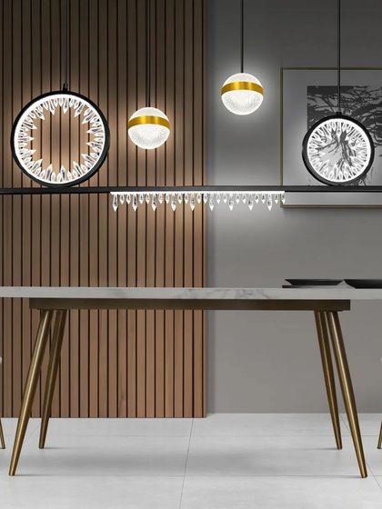 This linear pendant combines several different elements: crystal rings, globe lights, and hanging crystals. It's a unique and glamorous fixture for a modern dining table.