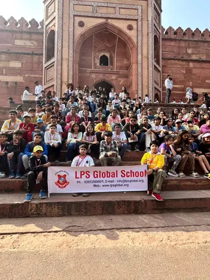 Our students gather for a group photograph with the school banner during their trip to Agra, representing our school with pride.