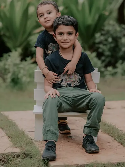 After all the running and playing, we took a moment for a sweet portrait. The natural affection between these two brothers shines through in this simple, relaxed pose during their kids photoshoot in Pune.