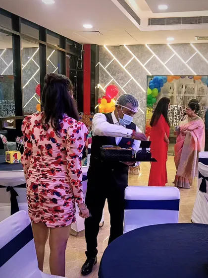 A member of my service team attending to a guest at a party. I believe in proactive and friendly service to make every guest's experience a pleasant one.