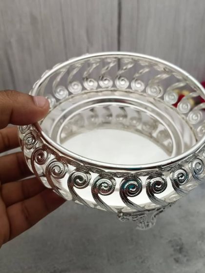 A hand-held view of a German silver tray with a swirled latticework border, a very elegant and popular design.