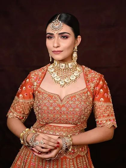 The art of subtle glam, perfected. This look is for the new-age bride who loves a pop of color. I paired a clean base and muted lips with a wash of pink on the lids to complement this beautiful orange outfit.