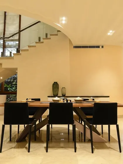 Creating delightful dining experiences. This space combines a modern dining set with an arched ceiling and views of the staircase, making every meal feel special.