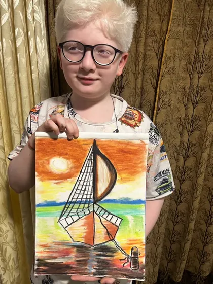 A student displays his beautiful sailboat drawing, capturing a sunset over the water. This artwork shows great progress in landscape and color techniques.