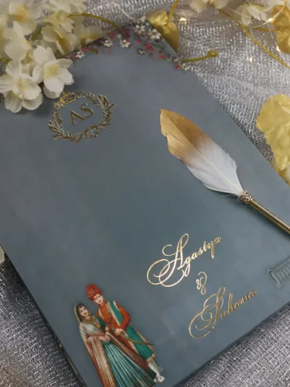 A sophisticated grey invitation with a custom gold-foil monogram and a classic illustration of a royal couple, perfect for an elegant affair.