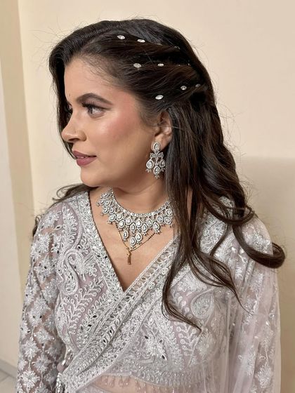 A beautiful client in a silver embroidered saree. I created a soft glam makeup look and a modern hairstyle with delicate accessories.
