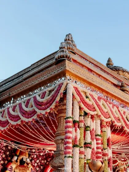 A closer look at the incredible detail of our temple-style mandap. The floral garlands of jasmine and rose add layers of texture and tradition to the grand structure.