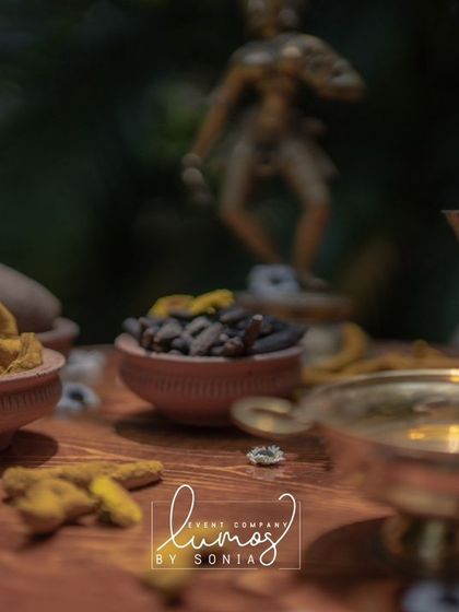 A close-up of the turmeric and other spices in small clay bowls, part of a vibrant Haldi ceremony setup.
