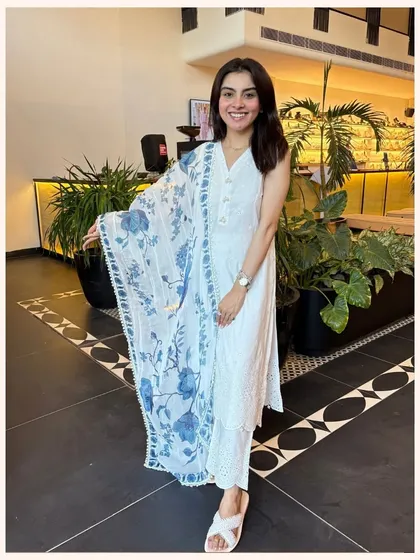 A classic white kurta with a twist. This set features a stunning blue floral printed dupatta that adds a vibrant pop of color.