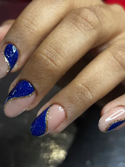 A striking abstract design using royal blue and a gold glitter line on a nude base.