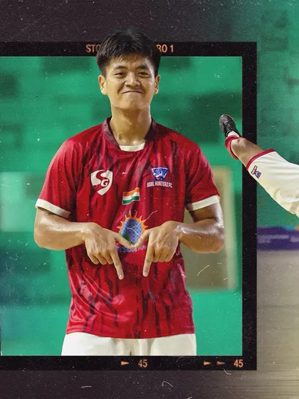 A player pointing to the club crest on his jersey, showing his love for the team.