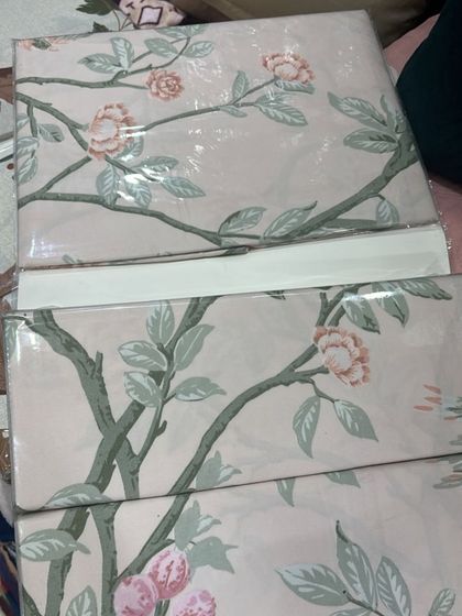 I love this chinoiserie-style print with delicate pink blossoms on branches. It's a very graceful and calming design, perfect for creating a peaceful bedroom retreat.