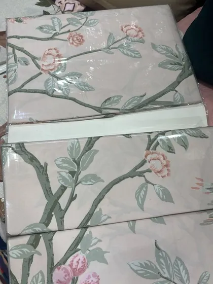 I love this chinoiserie-style print with delicate pink blossoms on branches. It's a very graceful and calming design, perfect for creating a peaceful bedroom retreat.