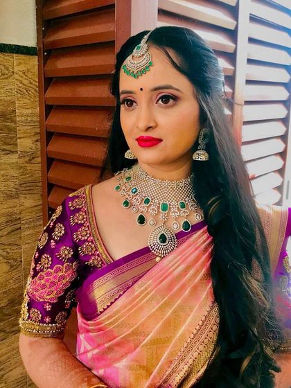 A portrait capturing the elegance of the Varapooje look. The makeup is soft yet defined, perfect for this important pre-wedding ceremony.