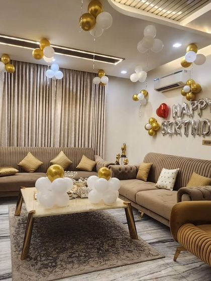 A clear, well-lit photo of the 75th birthday home decoration, showcasing the silver foil balloons and gold and white balloon clusters.