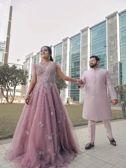 The classic "palat" moment, inspired by Bollywood. This wide shot shows the beautiful gown and the playful romance between the couple.