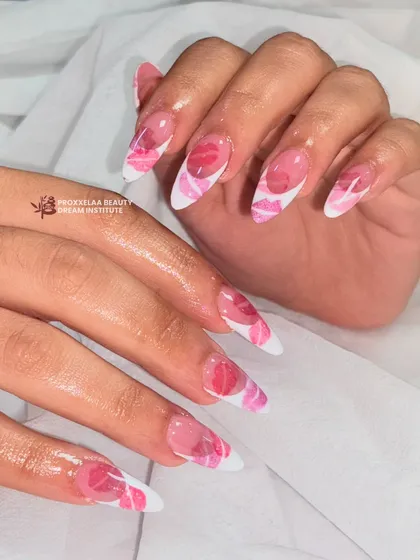 A different angle of the playful kiss-print nails, highlighting the glossy finish and the sharp almond shape.