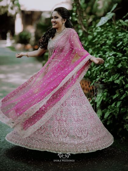 The bride-to-be twirling in her sparkling lehenga, a moment of pure joy and celebration captured perfectly.