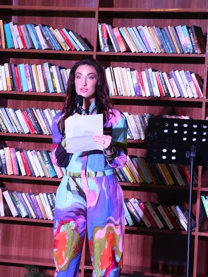 An international performer reading her work at our showcase. We frequently collaborate with artists from around the world to bring global perspectives to our stage.