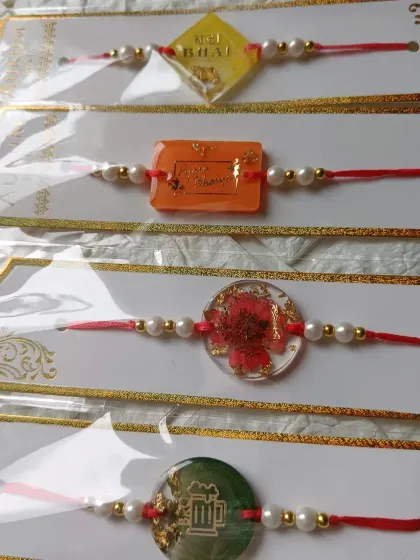 My rakhi collection includes something for everyone. Here you can see a floral design, one with a beer mug for fun, and another that simply says 'Bhai'.