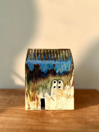 The glaze on this mini house is a stunning mix of blue, brown, and green, showing the beautiful and unpredictable results of high-temperature firing.