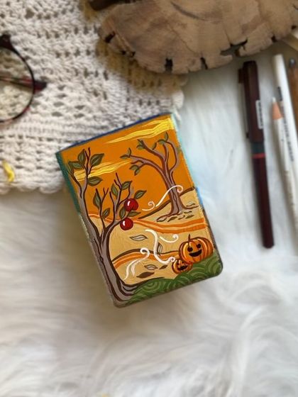 The Autumn side, with falling leaves, pumpkins, and a warm, earthy color palette.