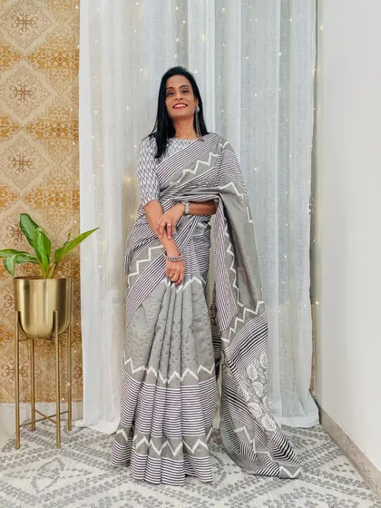 This grey and white geometric print saree is a very modern and chic option for the office. It's a versatile piece that can be styled in many different ways.