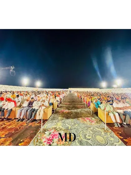 This image captures the scale of a grand wedding we organized, with seating arranged for a massive number of guests. The long, patterned aisle creates a spectacular pathway through the venue.