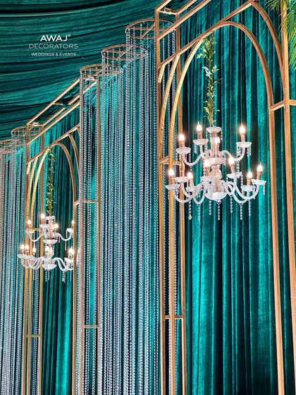 A detailed shot of the chandeliers and crystal curtains against the rich green velvet backdrop.