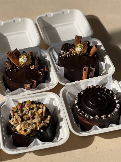 A collection of our chocolate bento cakes. These mini cakes are perfect for small, intimate celebrations and can be customized with different toppings.