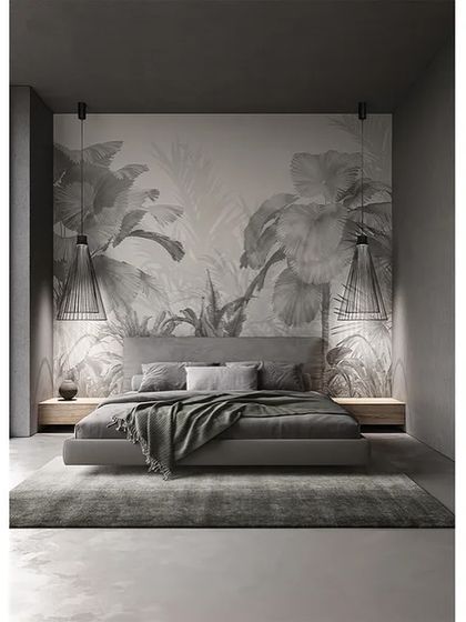 Two Ikonika pendants are used as bedside lamps in a dramatic, monochromatic bedroom, their simple forms flanking the bed and providing focused light for reading.