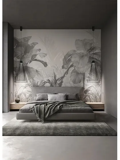 A pair of Ikonika pendants used as bedside lighting in a dramatic, monochromatic bedroom. The fixtures provide focused light for reading while adding a strong graphic element to the room.