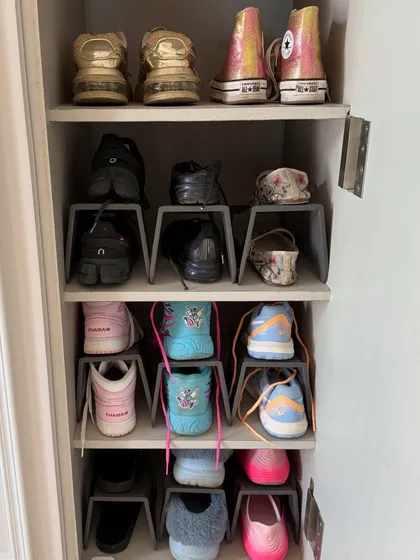 Even a small shoe cabinet can be highly efficient. These simple shoe stackers double the storage capacity, ensuring every pair from sneakers to flats has a home.