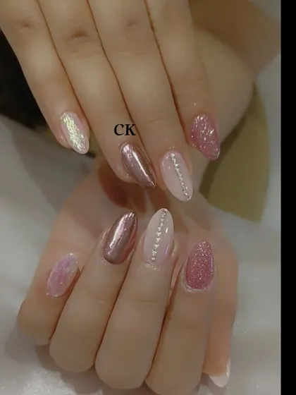 Another view of the rose gold set, showing the different textures and the almond nail shape.