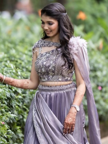 A candid moment in the garden, where the deep color of her henna art truly shines.