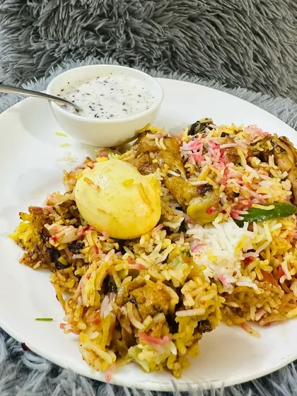 This is what a plate of my homemade biryani looks like, ready to be enjoyed. Served with a boiled egg and cool raita on the side.