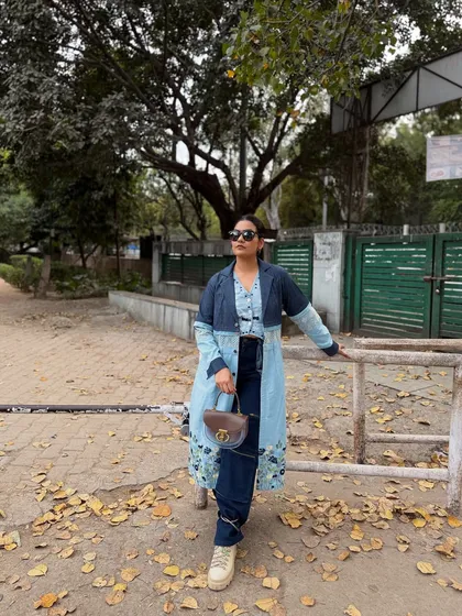 A full-length view that captures a confident, modern aesthetic, with the purse as the key accessory tying the look together.